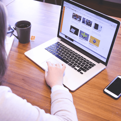 Person browsing a website on a laptop, illustrating the importance of regular SEO checks to maintain website performance and visibility.
